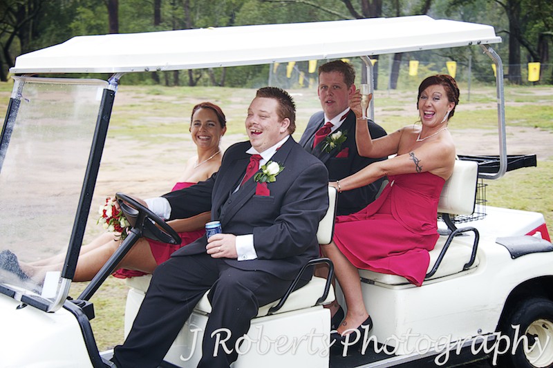 Bridal party cheering on golf buggies - wedding photography sydney
